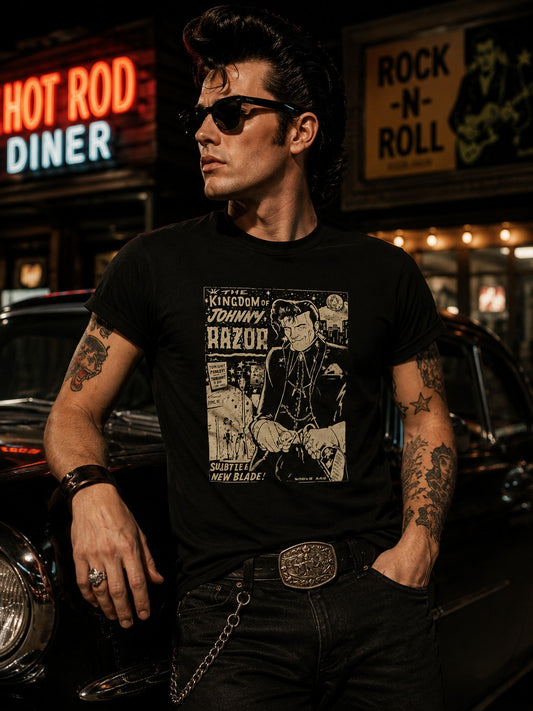 A man wearing a black graphic t-shirt with a vintage-style print of 'The Lone Ranger' stands in front of a blurred night-time diner and car background. The shirt features a large white and beige graphic of the character with the text 'The Lone Ranger' and 'Johnny Blaze'.